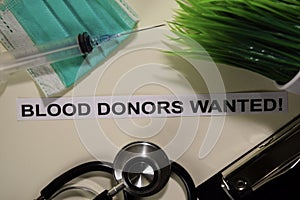 Blood Donors Wanted with inspiration and healthcare/medical concept on desk background photo