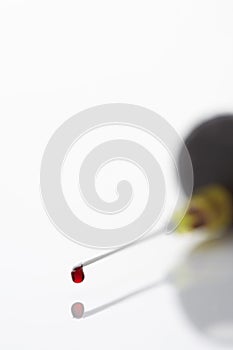 Blood droplet on syringe close-up