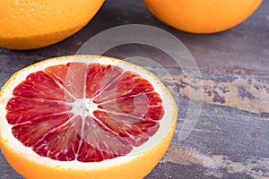 Blood oranges on gray slate