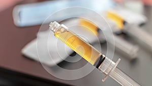 Blood plasma in a syringe on a blurred background. Blood plasma as a solution for the treatment of coronavirus