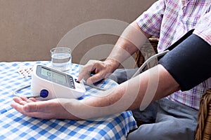 Blood pressure measure with heart rate check using digital device. Healthcare and medical concept.