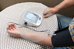 Blood pressure measure with heart rate check using digital device. Healthcare and medical concept.