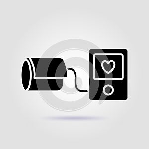 Blood pressure monitor black icon on gray background with soft shadow