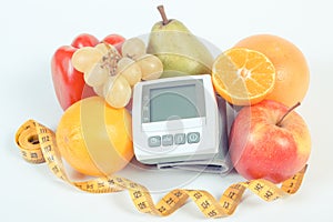 Blood pressure monitor, fresh ripe fruits with vegetables and centimeter, healthy lifestyle