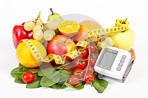 Blood pressure monitor, fresh ripe fruits with vegetables and centimeter, healthy lifestyle concept