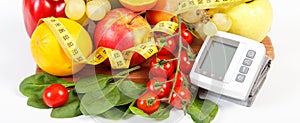 Blood pressure monitor, fruits with vegetables and centimeter, healthy lifestyle