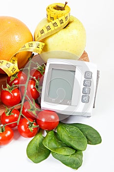 Blood pressure monitor, fruits with vegetables and centimeter, healthy lifestyle