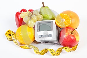 Blood pressure monitor, fruits with vegetables and centimeter, healthy lifestyle