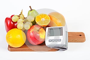 Blood pressure monitor and fruits with vegetables, healthy lifestyle