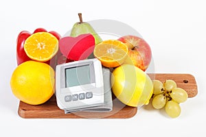 Blood pressure monitor and fruits with vegetables, healthy lifestyle and nutrition