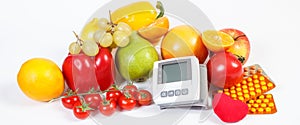 Blood pressure monitor, fruits with vegetables and medical pills, healthy lifestyle