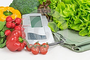 Blood pressure monitor and a pile of vegetables