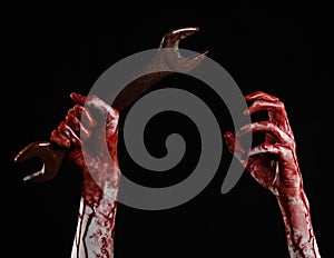 Bloody hand holding a big wrench, bloody wrench, big key, bloody theme, halloween theme, crazy mechanic, black background