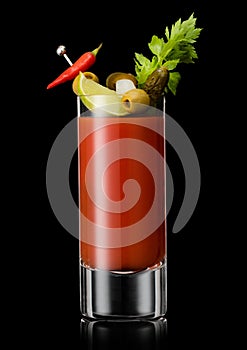 Bloody mary cocktail with hot red and green pepper and celery on black background