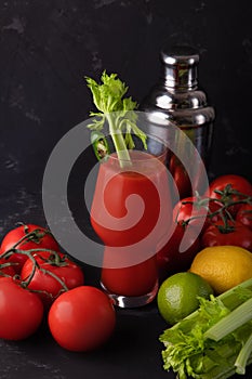 Bloody mary cocktail and ingredients on a black background