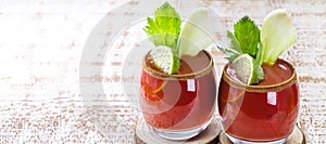 Bloody Mary cocktail and ingredients, copy space, on a white wooden background