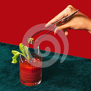 Bloody mary. Glass with cocktail  on bright green and red background. Concept of taste, alcoholic drinks