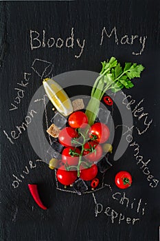 Bloody Mary ingredients on dark stone background