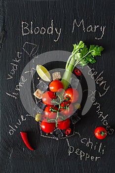 Bloody Mary ingredients on dark stone background