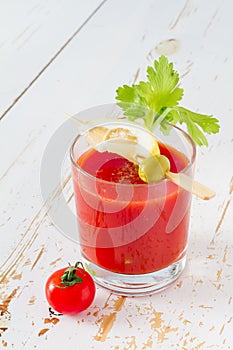 Bloody Mary ingredients on white wood background