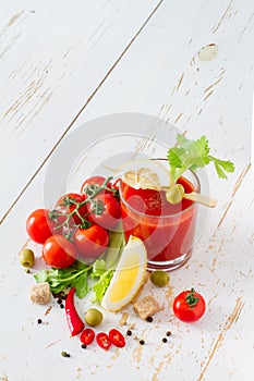 Bloody Mary ingredients on white wood background