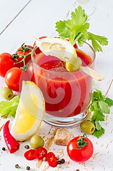 Bloody Mary ingredients on white wood background