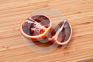 Bloody orange on a wooden surface side view close-up