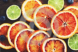 Bloody oranges and limes close up