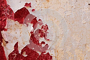 Bloody red paint peeling off from concrete cement wall