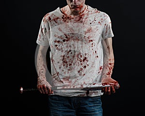 Bloody topic: The guy in a bloody T-shirt holding a bloody bat on a black background