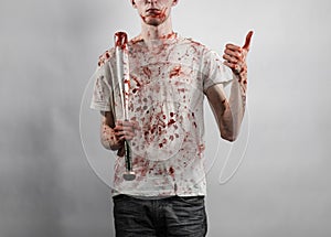 Bloody topic: The guy in a bloody T-shirt holding a bloody bat on a white background