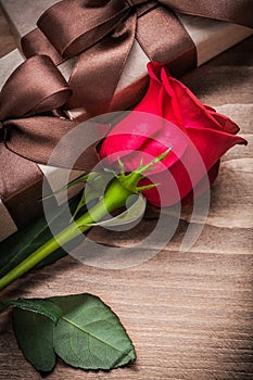 Bloomed red rosebud gift boxes on wooden board