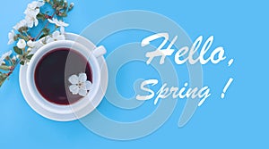 Blooming cherry, aroma a cup drink caffeine spring morning of coffee on a colored background