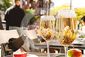 Blooming flower tea served in a wine glasses, at the trendy outdoor cafe