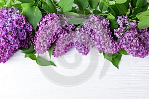 Blooming lilac flowers (syringa vulgaris) on white rustic wooden table. Top view banner with copy space photo