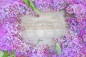 Blooming lilac flowers on wood