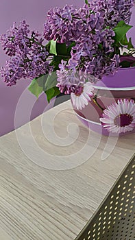 Blooming lilac in the garden against the blue sky and in the interior. Garden trees, country harvest. copy space
