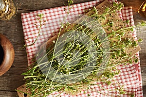 Blooming shepherd\'s purse herb on a table - ingredient for tincture