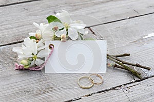 blossom branches and card with copy space on a wooden background