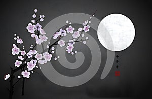 Blossoming branch of oriental cherry and the moon in dark night sky. Traditional oriental ink painting sumi-e, u-sin, go