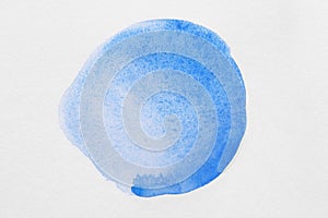 Blot of blue watercolor paint on white background, top view
