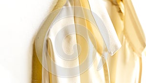A blouse or shirt in white hanging on clothes hanger on white background.Close up
