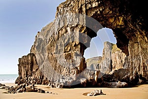 Blow hole forming a rock archway beneath the Pembroke Coastline between Lydstep and Manorbier Bay