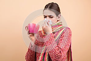 Blow from the snot. Woman in sweater and scarf hold napkin blow snot from nose isolated on yellow. Mucus flowing from