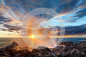 Blowhole on rocky coastline photo