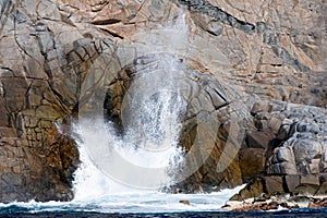 Blowhole spouting water photo