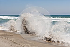 Blowholes on beach photo