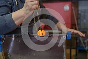 Blowing glass souvenir in glasswork in czechia, human hands make glass produst