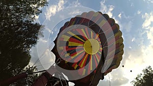 Blowing inflating with fire from gas burner of large balloon aerostat.