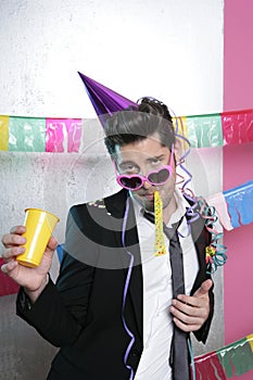 Blowing noisemaker suit party funny young man photo